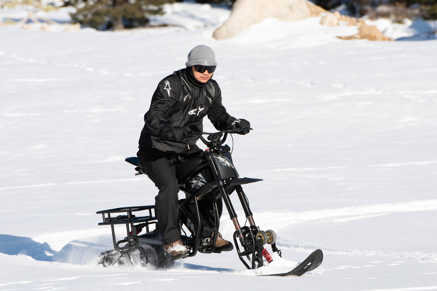 Person riding a snow Ebike GT73 Pro on a snowy landscape