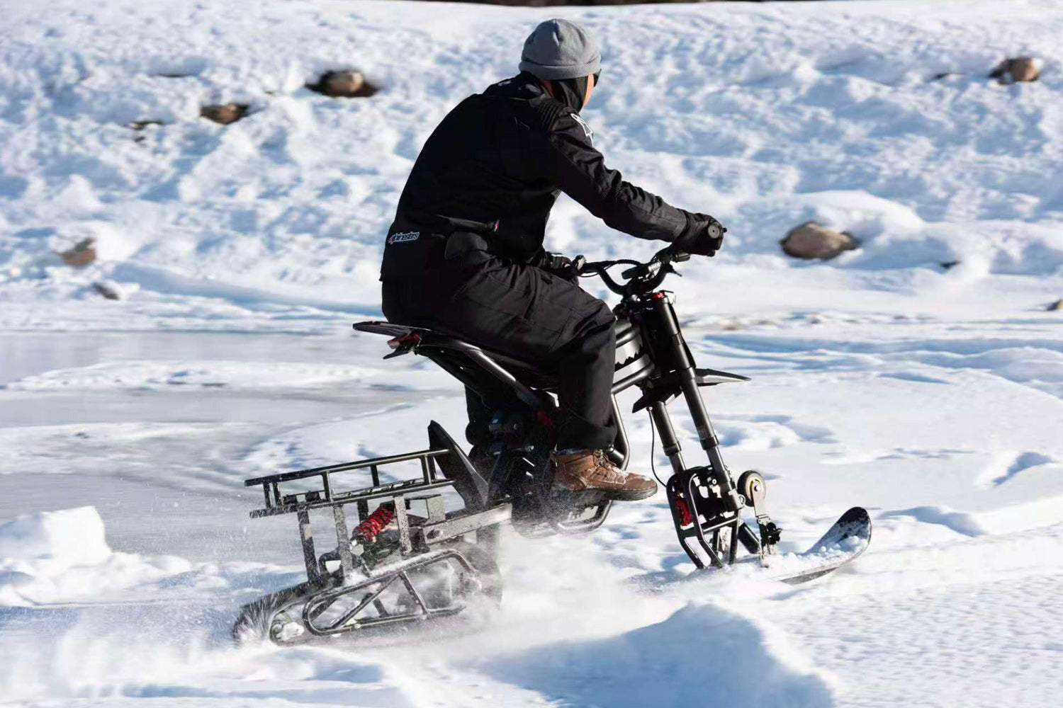 Person riding a snow bike GT73Pro on a frozen lake