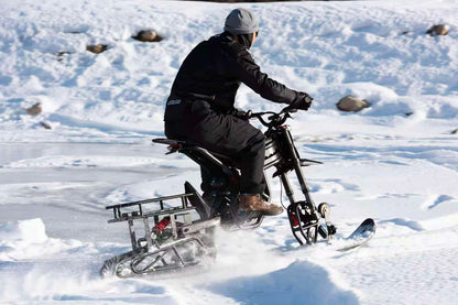 Person riding a snow bike GT73Pro on a frozen lake