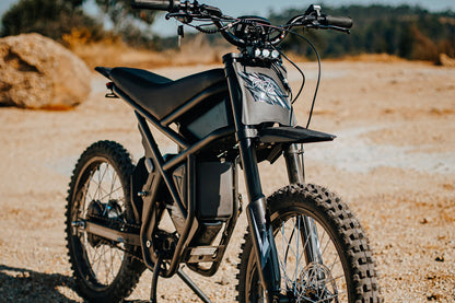 Black electric bike GT73 on a dirt road with blurred background
