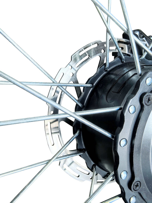 Disc Brake on a bicycle wheel hub featuring silver spokes and a perforated metal rotor disc