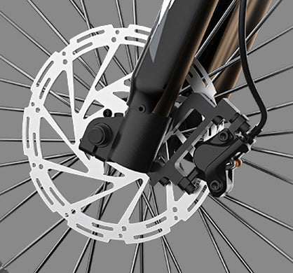 Disc Brake Rotor silver metal with perforated circular design mounted on black bicycle fork with brake caliper and spokes