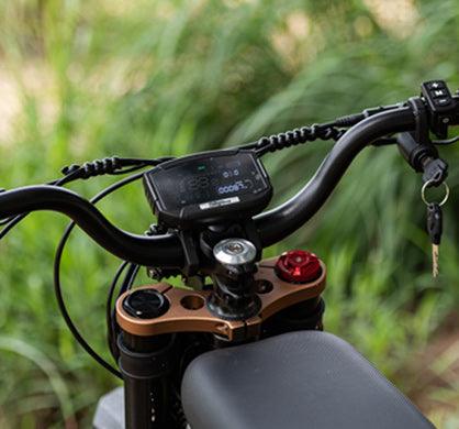 Ebike model digital display mounted on black handlebars with integrated key ignition and control buttons