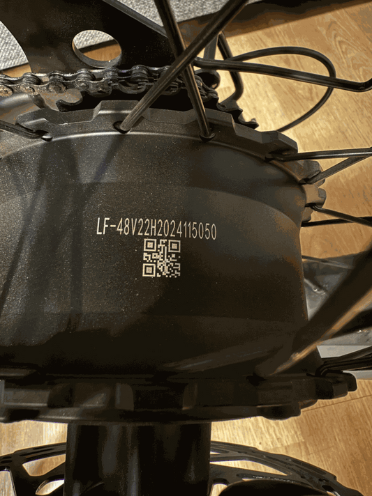 Motor black metal ebike hub motor with serial number LF-48V22H2024115050 and QR code on casing
