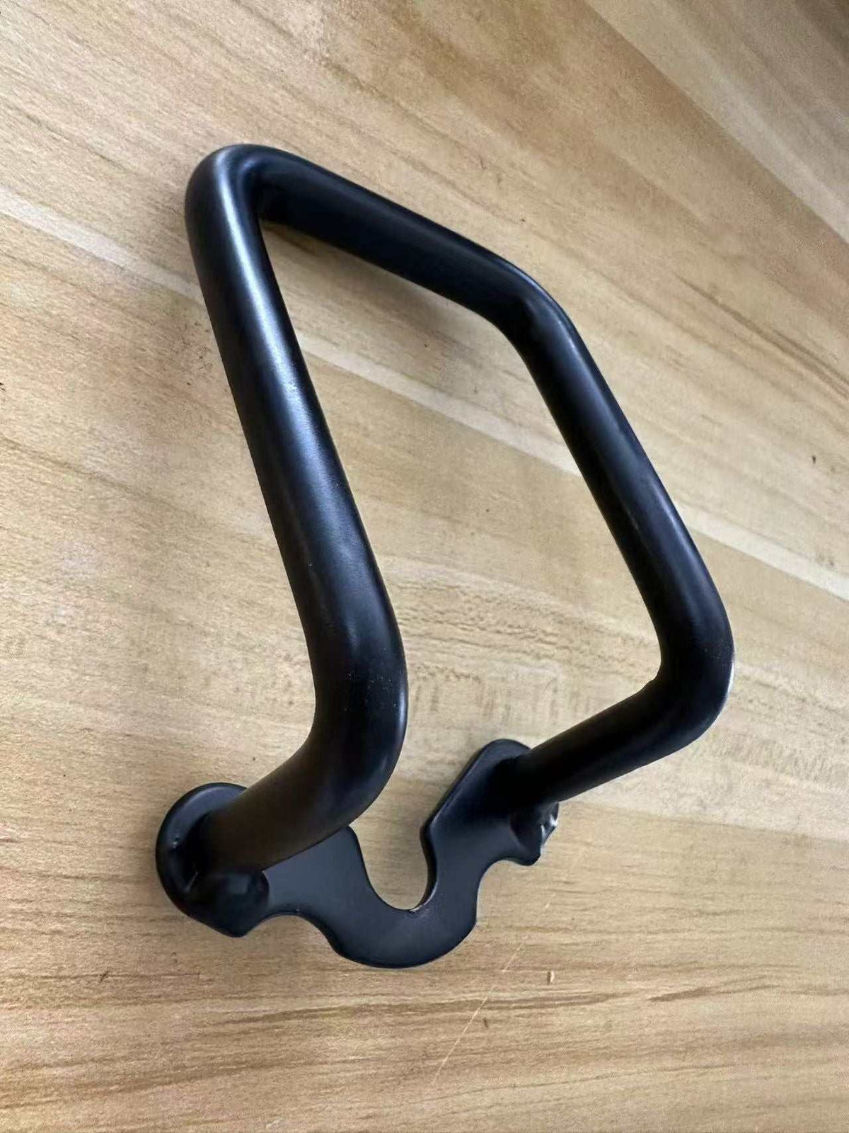 Black metal Rear Derailleur Protector with a sturdy curved frame and mounting points for secure attachment