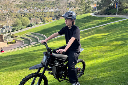 GT73 Electric Motorbike with rider outdoors, featuring off-road tires.