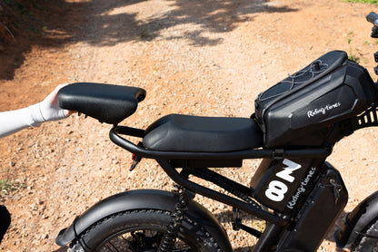 Z8 removable seat extension in black textured material being attached to a black electric bike with cushioned main seat and rear cargo bag